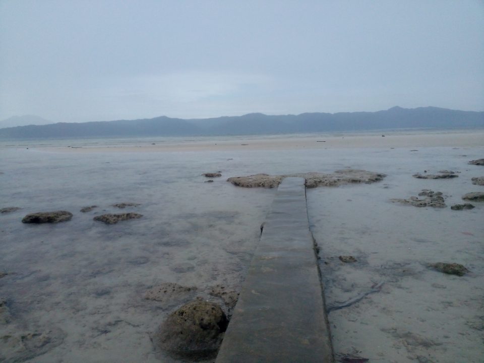 A cemeted path in front of the resort going to the shore. Shot taken during a mild rain.